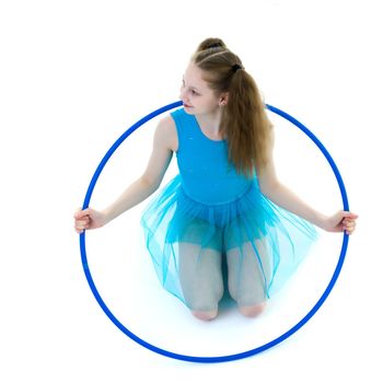 A girl gymnast performs an exercise with a hoop. The concept of gymnastics and fitness. Isolated on white background.