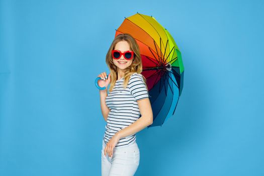 pretty woman fashion posing colorful umbrella blue background. High quality photo