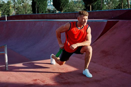 athletic man in red jersey workout exercise pumped up body. High quality photo