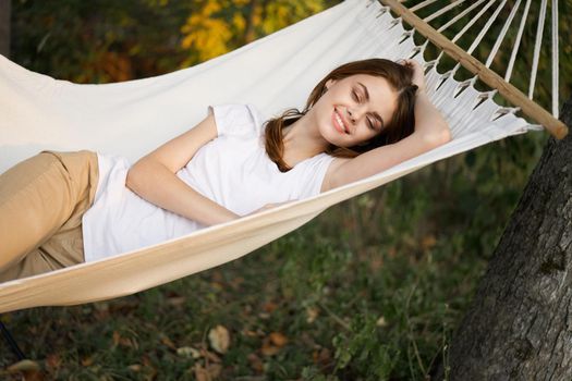 cheerful woman lies in a hammock rest nature fresh air. High quality photo