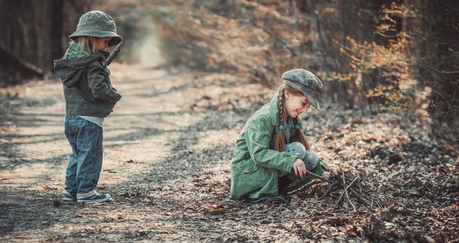 small children play in the woods, photo in vintage style