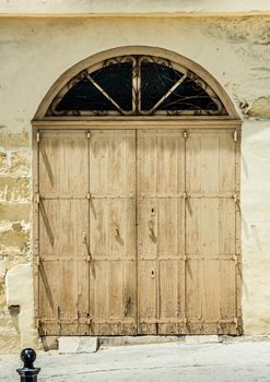 wooden garage doors in a street of Valletta historical center in Malta