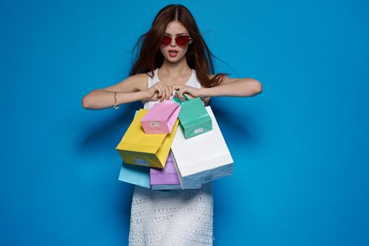 smiling woman wearing sunglasses posing shopping fashion studio model. High quality photo