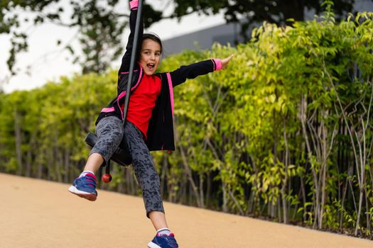 The little girl on the bungee jumping for kids outdoor.