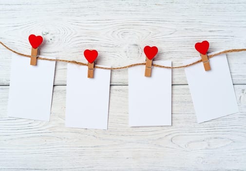 Heart clothespins on rope. Creative background with copy space, top view