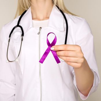 Female doctor in white uniform with purple awareness of ribbon in hand for ADD,ADHD,Alzheimer Disease ,Arnold Chiari Malformation,Childhood Hemiplegia stroke, Epilepsy, Chronic Acute Pain,Crohns - Image