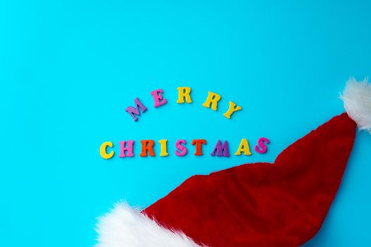 Words Merry Christmas on blue background top view, copy space