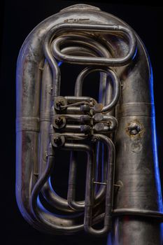 fragment of silver tuba isolated on black background