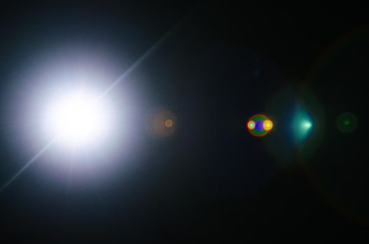 Abstract Natural Sun flare or Far star on the black background - image
