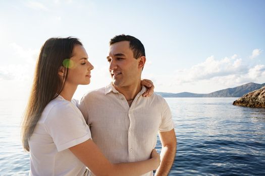 Happy couple in love on a yacht in summer on romantic vacation