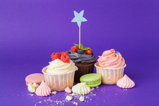 Beautiful cupcake against saturated dark purple background