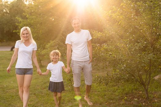 happy young family spending time outdoor on a summer day