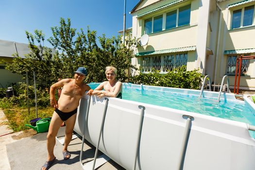 close up of pensioner man in the pool swimming, active people and healthy and fit senior, lifestyle of active mature man