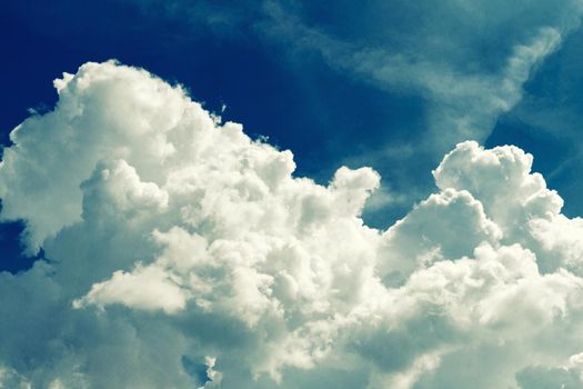 Incredibly wonderful lush cumulus clouds against a blue sky - Image toned