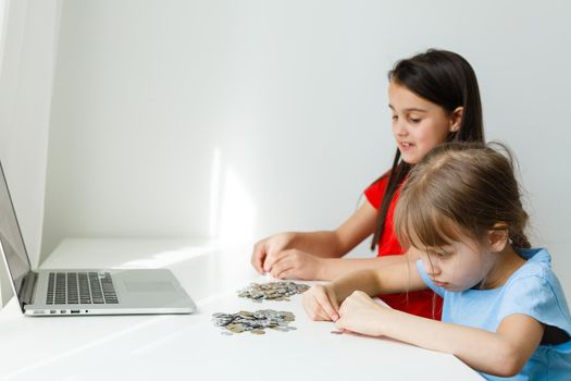 Two kids counting coins together