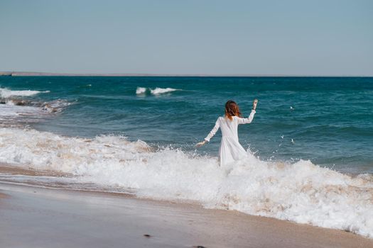 Woman in white dress near the ocean walk fresh air landscape. High quality photo