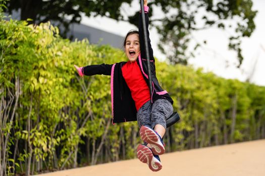 Little girl rushes on a bungee