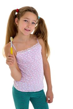 Smiling girl standing with toothbrush in her hands. Preteen girl brushing her teeth before or after sleeping. Cute child daily routine concept