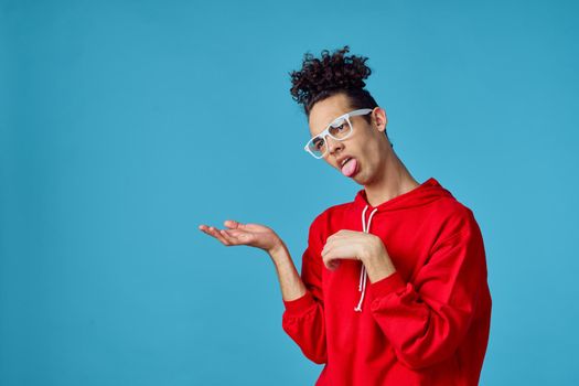 curly guy in a red sweater posing fashion modern hipster style. High quality photo
