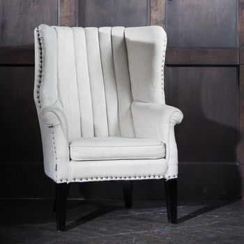 Old white Retro Armchair against wooden walls of red aged wood