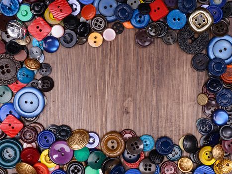 Wooden background with old fashion assorted buttons with copy spase.