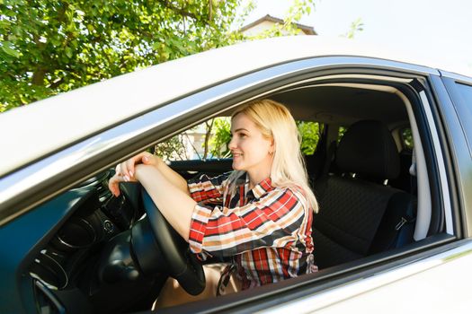 Smiling woman sitting in car