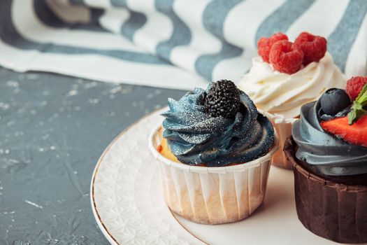 Group of cupcakes on dark background selective focus
