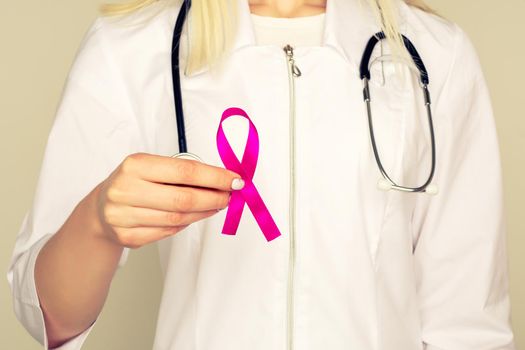 Female Doctor Holds Pink Ribbon, International Breast Cancer Day October 7 - Image
