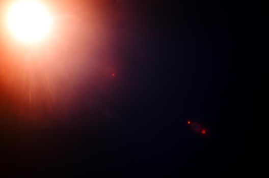 Abstract Natural Sun flare or Far star on the black background - image