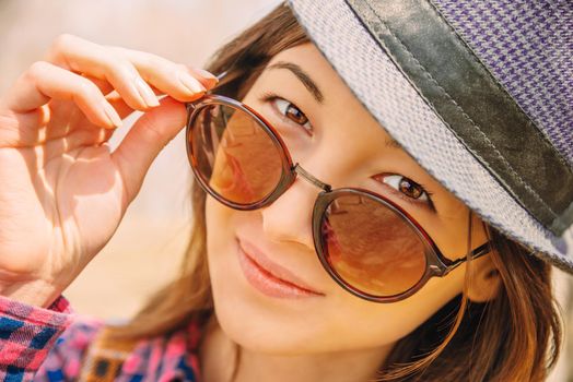 Portrait of smiling hipster woman in glasses and hat