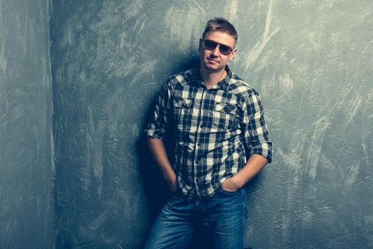 portrait of the man in sunglasses and plaid shirt