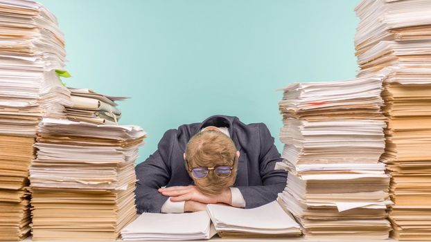 Close-up image of a stressful businessman tired from his work on the foreground - image