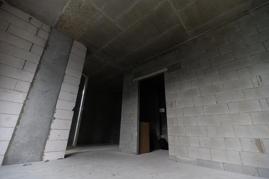 Small apartment without repair in a new building. A room in an unfinished house. Walls of foam block and concrete floor in a tiny apartment.