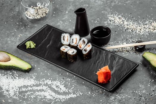 Simple maki with tuna. Sushi on a gray background.