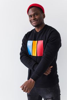 Handsome African American man posing in black hoodie on a white background. Youth street fashion photo with afro hairstyle