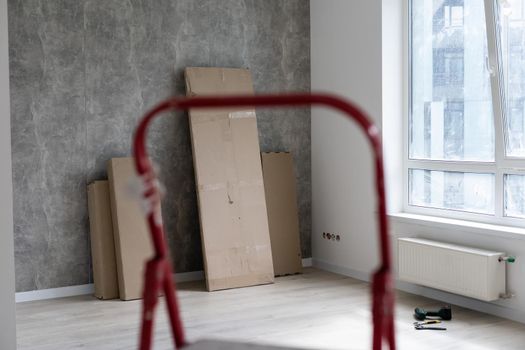Interior of apartment with materials during on the renovation and construction, remodel wall from gypsum plasterboard or drywall