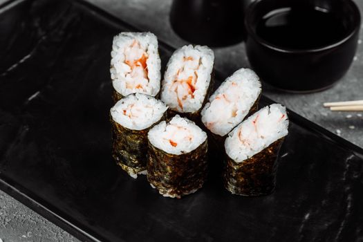 Simple maki with shrimp. Sushi on a gray background.