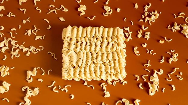 Instant noodles asian ramen. Dry yellow raw food noodles. pasta, for the preparation of which it is enough to pour boiling water and wait a few minutes. Copy space korean and japanese vermicelli