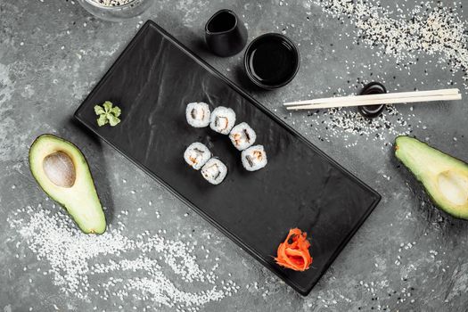 Simple maki with tuna. Sushi on a gray background.