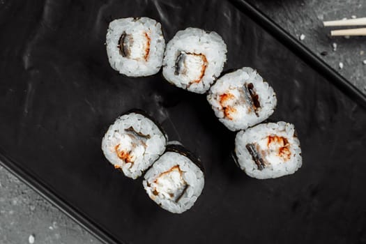 Simple maki with tuna. Sushi on a gray background.