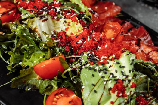 Salmon salad gravlax. Smoked salmon salad, with mixed greens cherry tomatoes avocado black olives carrots sprouts cucumber and lime. Delicious healthy eating.