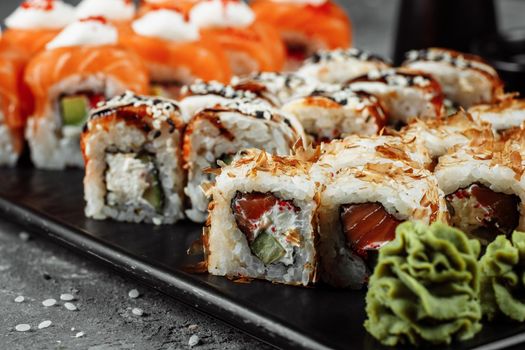 Sushi set with fresh ingredients on gray background. Sushi menu. Japanese food.