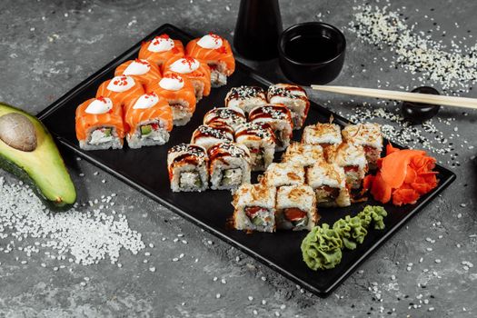 Sushi set with fresh ingredients on gray background. Sushi menu. Japanese food.