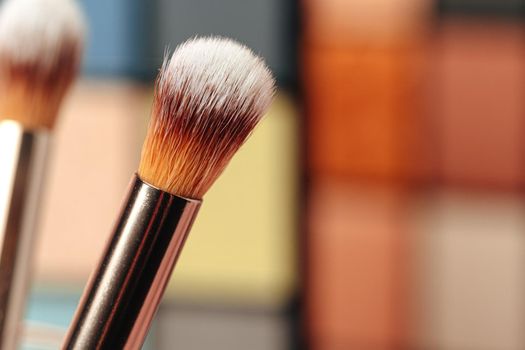Make-up palette and brushes. Professional eyeshadow palette. Close up.