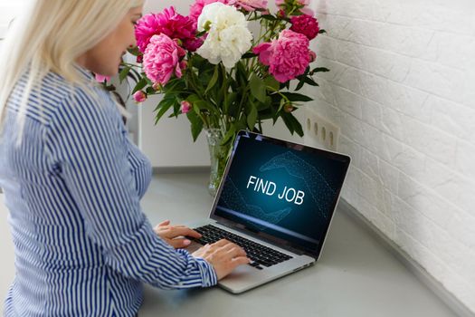 Unemployed young woman searching online for job