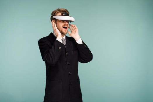 Businessman in a formal wear wearing virtual reality glasses opened his mouth in surprise - image