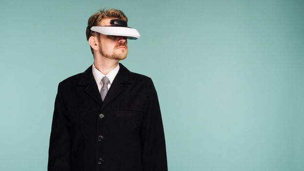 Businessman in a formal wear wearing virtual reality glasses - image