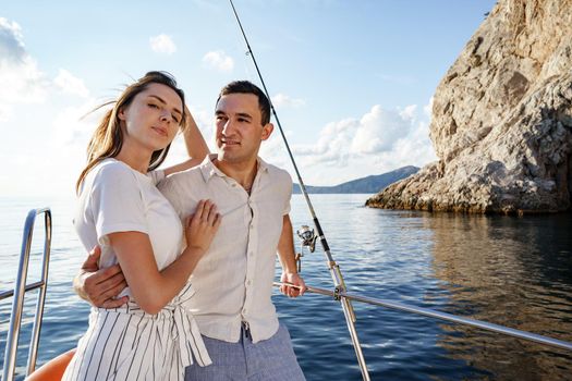 Happy couple in love on a yacht in summer on romantic vacation