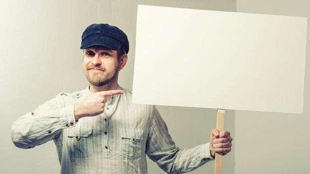 Angry protesting worker with blank protest sign.