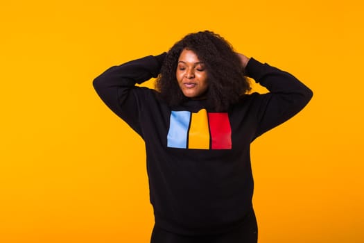 Young beautiful african american girl with an afro hairstyle. Portrait on white background. Girl looking aside